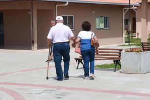 Casal de idosos caminham em calçada